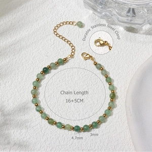 Detailed view of 4.7mm green stone beads with 3mm gold spacers and stainless steel clasp