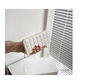 Detail of white quilted leather long wallet for women with golden zipper closure