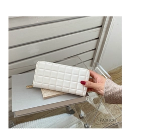 Detailed view of white quilted PU leather long wallet with gold zipper for women