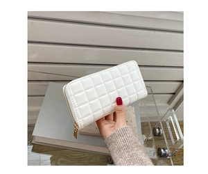 Detailed view of ivory quilted leather wallet with gold zipper and textured grid pattern