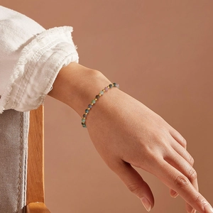 6mm Rose Quartz and Obsidian beaded bracelet with gold beads on a woman's wrist