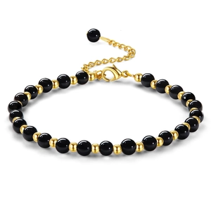 Detail of beaded bracelet showing lobster clasp and adjustable golden extender chain