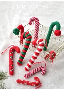 Close-up of knitted candy cane Christmas tree ornaments with red and white wool textures