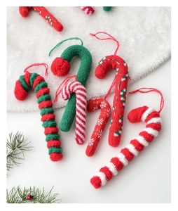 Macro view of six knitted candy cane ornaments in festive red, green and white colors