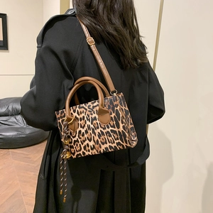 Fashionable leopard print shoulder bag with brown top handles and adjustable strap for women