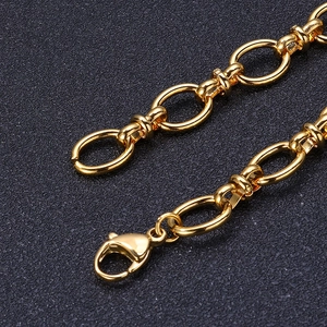 Macro detail of gold plated stainless steel oval link chain with lobster clasp closure