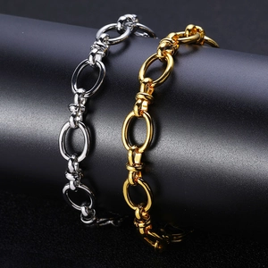 Close-up of gold and silver polished oval link chain bracelets on a black display stand