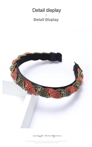 Detail of twisted headband with red, green, and gold rhinestone chain patterns