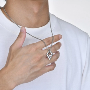 Close-up of a men's geometric rhombus pendant necklace in polished silver stainless steel