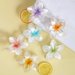 Set of six colorful plumeria flower hair claws with a pearlescent finish and gradient colors