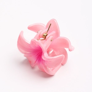 Detailed view of a pink gradient lily flower hair claw clip with a strong golden spring