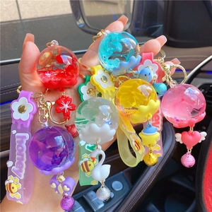 Detail of colorful dried flower crystal ball keychains with silicone honey wrist straps