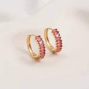 Close-up of 14K gold plated hoop earrings with rectangular pink zircon channel setting