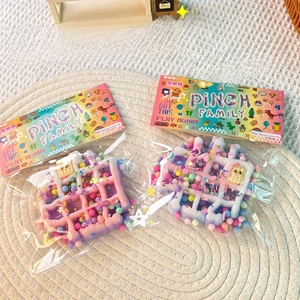 Detail of macaron gradient waffle squishy toys with colorful beads in pinch family packaging