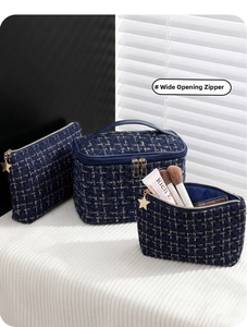 Three-piece dark blue tweed cosmetic bag set with decorative gold star-shaped zippers