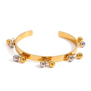 Polished gold open bangle featuring contrasting gold and silver bead charms on white background