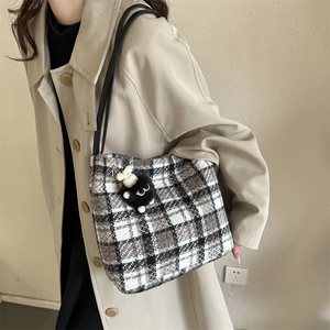 Classic black and brown checkered tweed tote bag with plush charm and black shoulder straps