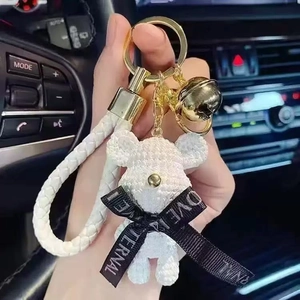 Cute white pearl texture bear keychain with gold hardware and white braided leather strap