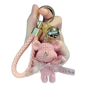 Pink hand-knitted 3D bear keychain with gold bell and woven strap for bags