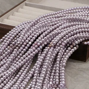 Macro shot of lavender pearl beads on a wooden tray for DIY jewelry making crafts