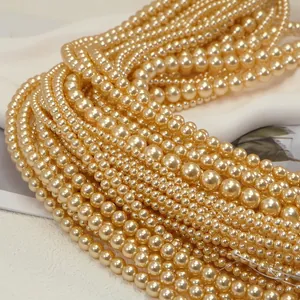 Close-up of champagne gold round pearls with glossy finish for DIY jewelry crafts