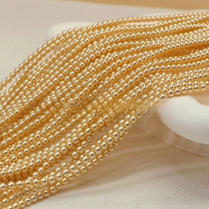 Macro detail of high-luster champagne gold round pearls for DIY jewelry making
