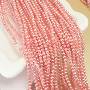 Close-up of pink round faux pearl beads strands for DIY jewelry making and crafting