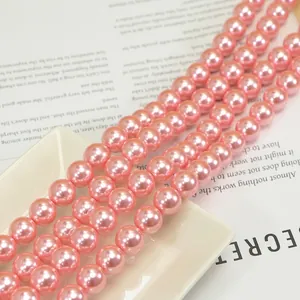 Macro detail of high-luster pink round pearls for DIY jewelry making and necklace crafts