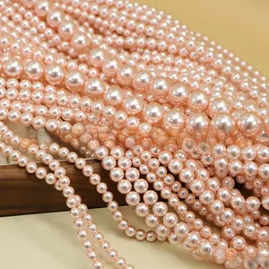 Macro shot of high-gloss round pink faux pearl loose beads for DIY jewelry making