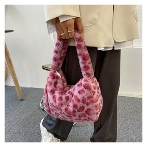 Detail view of pink leopard faux fur handbag with soft texture and metallic zipper