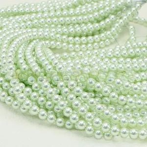 Macro detail of light green faux pearls on strings for DIY jewelry making