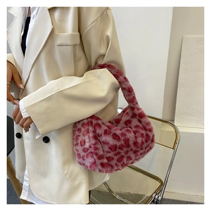 Detail of pink leopard faux fur shoulder bag worn with a white blazer for autumn
