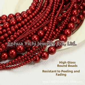 Macro detail of glossy burgundy round pearls in various sizes for DIY jewelry crafting