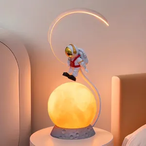 Levitating astronaut moon lamp with LED arc and rock base for bedroom night light
