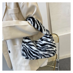 Close-up of zebra print faux fur texture on a shoulder bag with soft plush finish