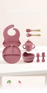 Detail of 9-piece silicone baby feeding set in rose pink with wood handle utensils