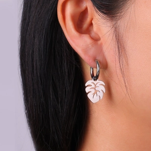 Silver stainless steel monstera leaf drop earrings on model for a tropical minimalist look