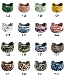 Macro display of 16 vibrant patterns on elastic wide headbands for yoga and sports