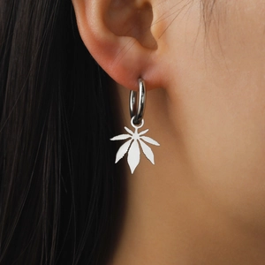 Silver maple leaf drop earrings made of stainless steel on model for a trendy look