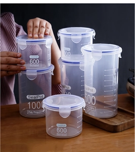 Stack of clear plastic food storage containers with blue seals and visible scale markings