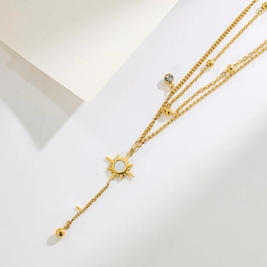 Three-layer gold titanium steel necklace with star pendants and sun charm on white background