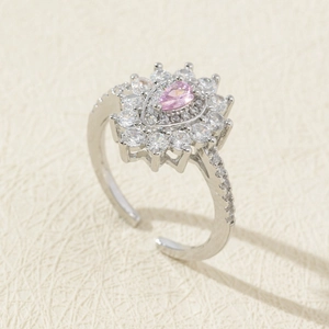 Detail of silver adjustable ring with pink pear-cut zircon and floral halo design