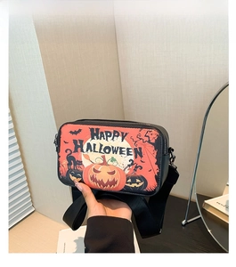 Detail of black Halloween crossbody bag with pumpkin and bat prints in daily setting