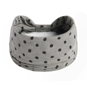 Macro detail of grey elastic headband with black polka dots and gathered back seam
