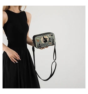 Detail of Halloween crossbody bag featuring vintage witch and bat prints with dual zippers
