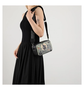 Detail of Halloween crossbody bag with witch and gothic castle print on black faux leather