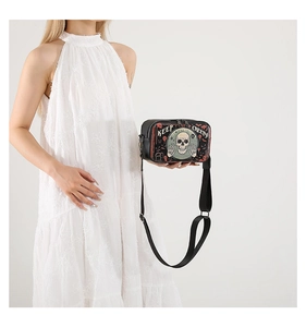 Detail of Halloween crossbody bag with Keep Creepy skull print and wide shoulder strap