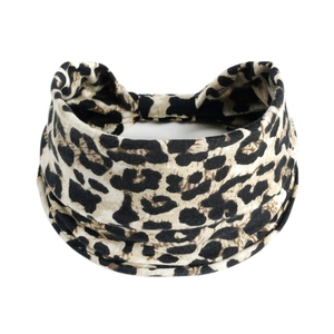 Close-up of leopard print elastic headband with twist detail and soft knit texture