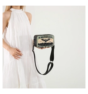 Detail of crossbody bag featuring Halloween prints with forest and bats on white background