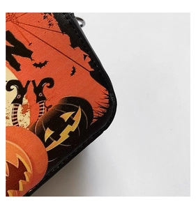 Macro view of Halloween print texture and stitching on the faux leather shoulder bag
